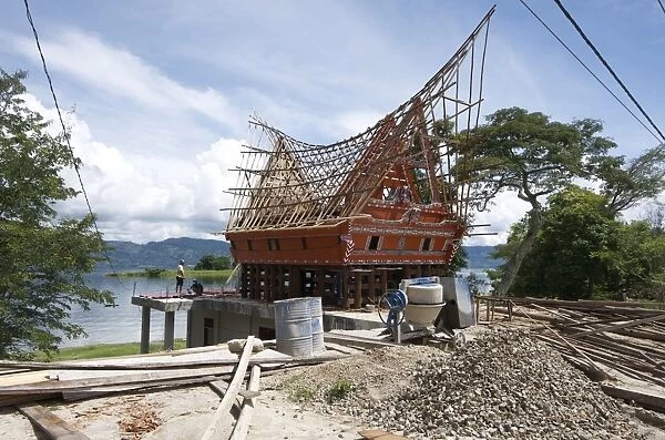 Construction of traditional style Batak house with bamboo scaffolding, beside the volcanic Lake Toba, Samosir Island, Sumatra, Indonesia, Southeast Asia, Asia