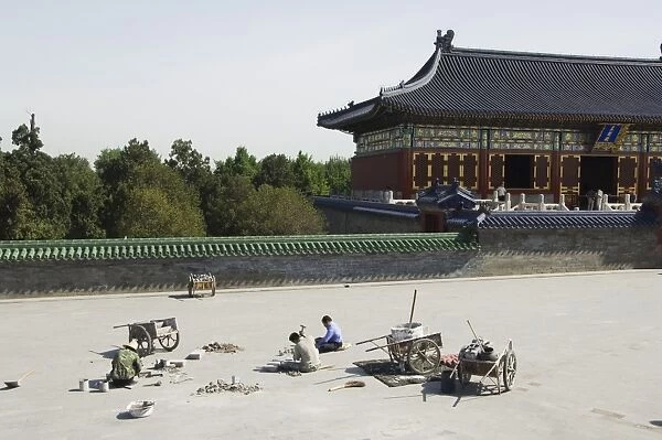 Construction workers repairing the square at The Temple of Heaven, UNESCO World Heritage Site