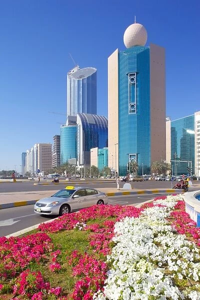 Contemporary architecture and taxi on Rashid Bin Saeed Al Maktoum Street, Abu Dhabi, United Arab Emirates, Middle East