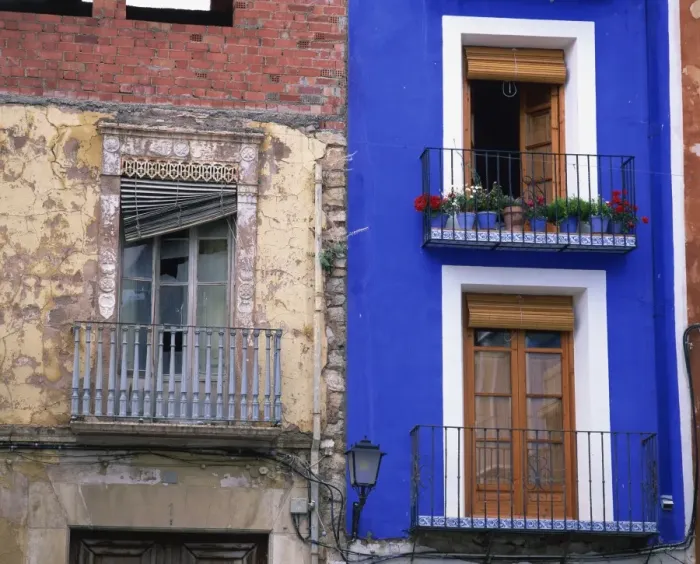 Framed Print : Contrast between derelict and bright blue painted lived Framed Print : Contrast between derelict and bright blue painted lived