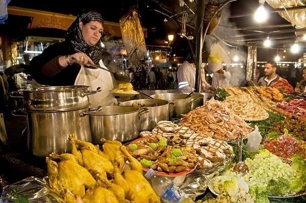Cook selling food from her stall in the Djemaa el Fna (Place Jemaa El Fna)