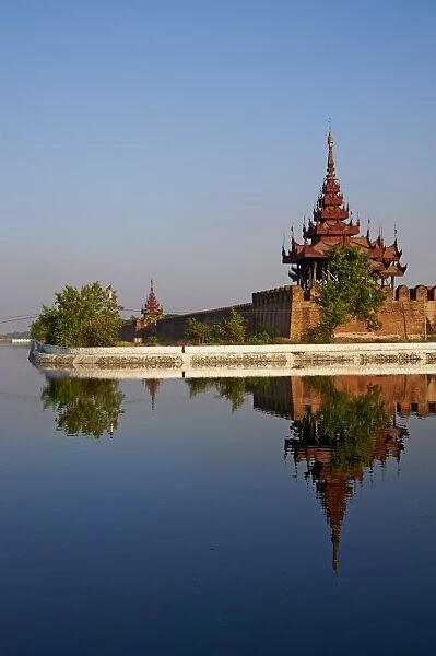 Corner of the surrounding wall reflected in the moat, Mandalay Palace, Mandalay, Myanmar (Burma), Asia