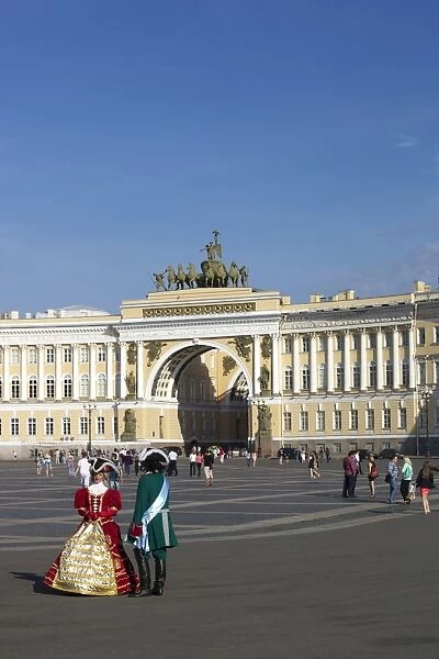 Costumed figures in Palace Square, and General Staff Building, Palace Square, St. Petersburg, Russia, Europe