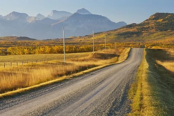 Country road through a mountainous landscape, near Twin Butte, Alberta, Canada, North