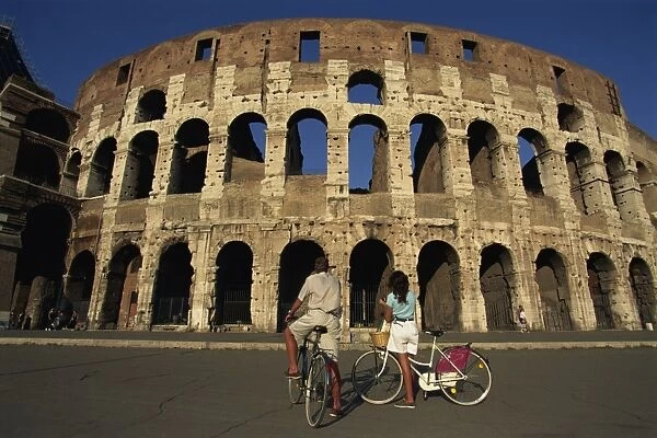 Couple admiring the Colosseum on bike ride