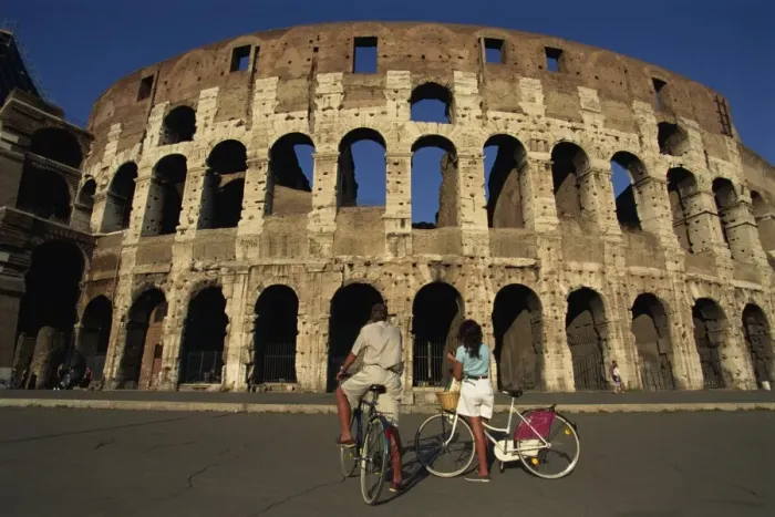 Framed Print : Couple admiring the Colosseum on bike ride Framed Print : Couple admiring the Colosseum on bike ride