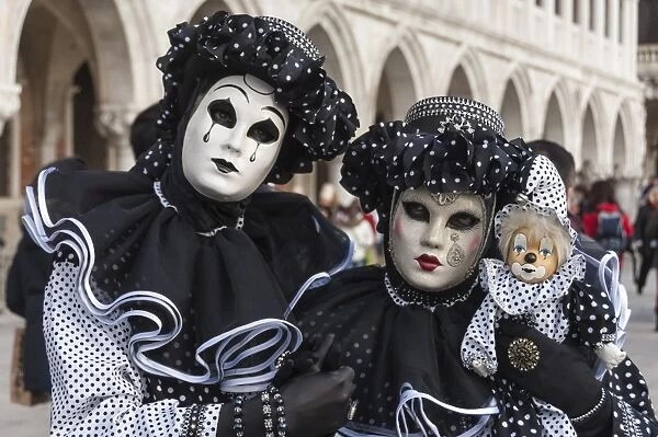 Couple in black and white with clown puppet, Venice Carnival, Venice, Veneto, Italy