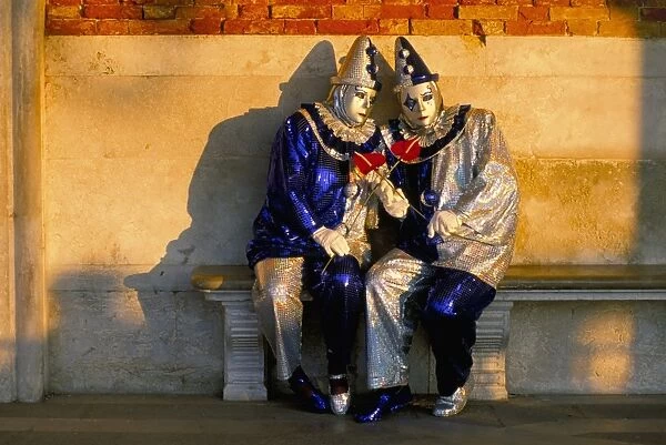 Couple dressed in masks and costumes taking part in Carnival
