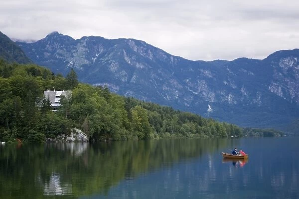 Couple fishing from a boat, Lake Bohinj, Slovenia, Europe