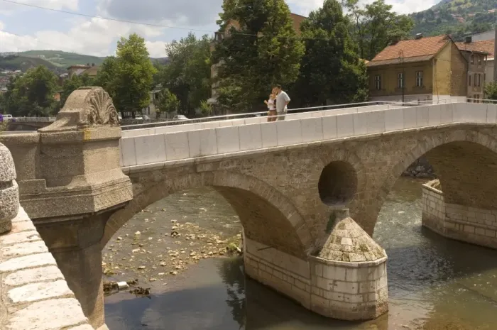 Framed Print : Couple on the Latin Bridge (Latinska cuprija), across the River Miljacka Framed Print : Couple on the Latin Bridge (Latinska cuprija), across the River Miljacka