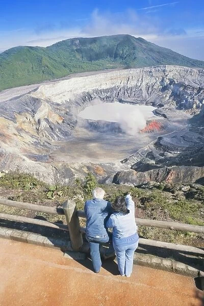 Couple looking at Poas Volcano, Poas Volcano National Park, Costa Rica, Central America