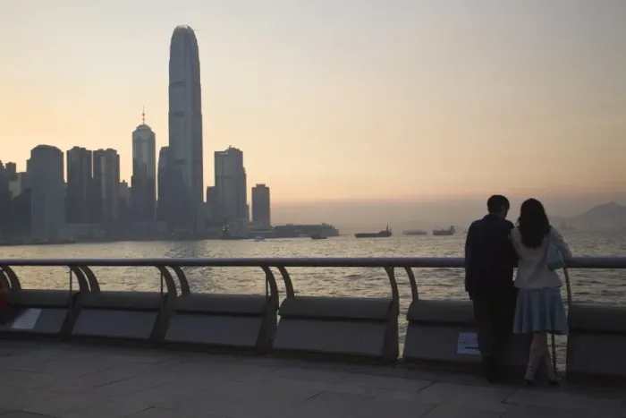 Framed Print : Couple looking at Victoria Bay and city skyline at sunset, Hong Kong, China, Asia Framed Print : Couple looking at Victoria Bay and city skyline at sunset, Hong Kong, China, Asia