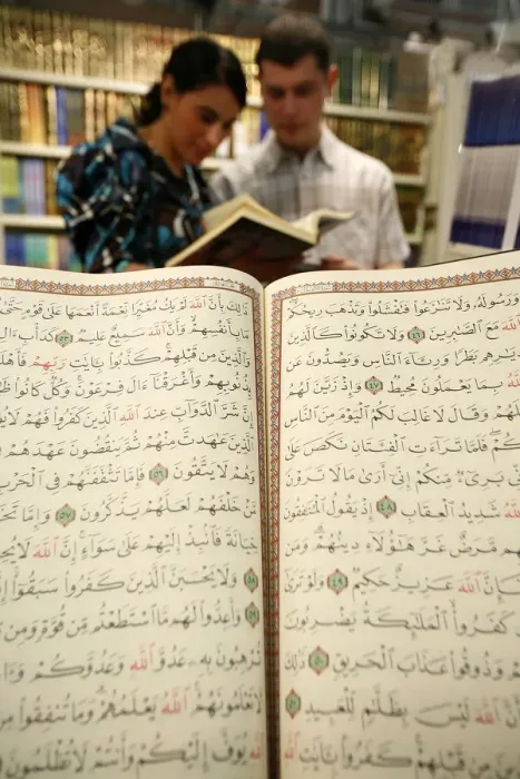 Framed Print : Couple reading the Koran at U. O. I. F. annual meeting, Paris, France, Europe Framed Print : Couple reading the Koran at U. O. I. F. annual meeting, Paris, France, Europe