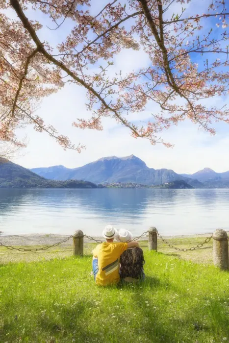 Framed Print : Couple of tourists sitting in front the lake. Lierna, Province of Lecco, Como Lake Framed Print : Couple of tourists sitting in front the lake. Lierna, Province of Lecco, Como Lake