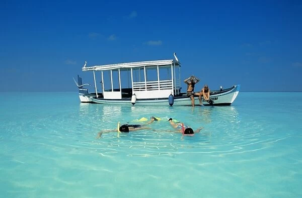 Two couples snorkelling in the Maldives, Indian Ocean, Asia