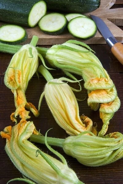 Courgette flowers and sliced courgette, Italy, Europe
