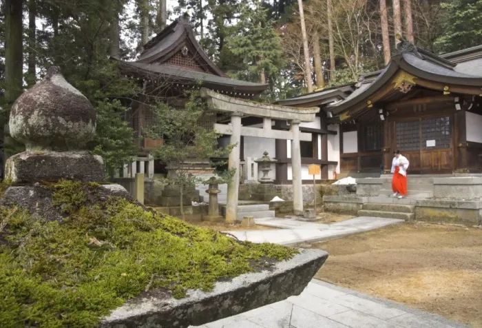 Framed Print : Courtyard with temple buildings and female priest wearing Framed Print : Courtyard with temple buildings and female priest wearing