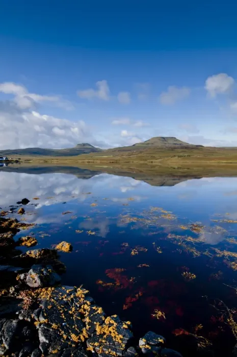 Framed Print : Craggy seascape of Loch Dunvegan on the Isle of Skye, with Macleods Table in background. Isle of Skye, Inner Hebrides, Scotland, United Kingdom, Europe