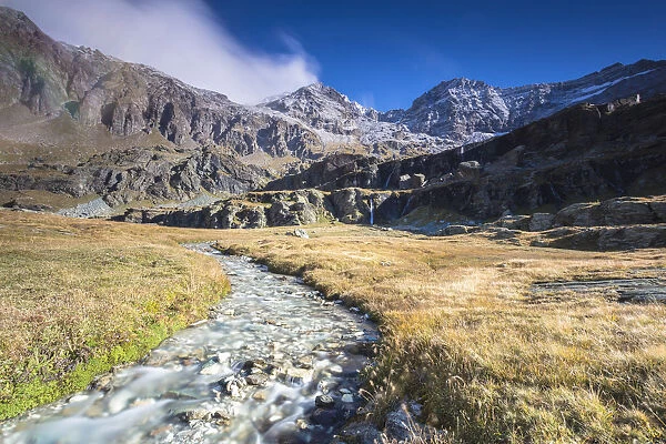 Creek flowing between meadows, Alpe Fora, Malenco Valley, province of Sondrio, Valtellina
