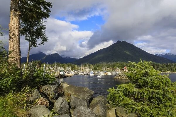 Crescent Boat harbour with beautiful wooded mountains and town of Sitka, rare sunny day