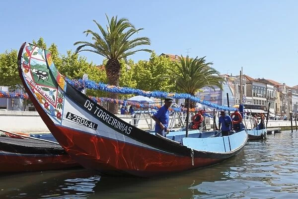 The crew prepares a colourful Moliceiro boat for a sightseeing tour along the canals of Aveiro