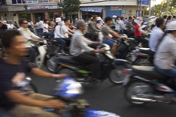 Crowd of people riding mopeds