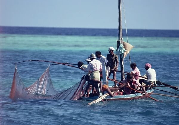 Crowded fishing boat raising its nets