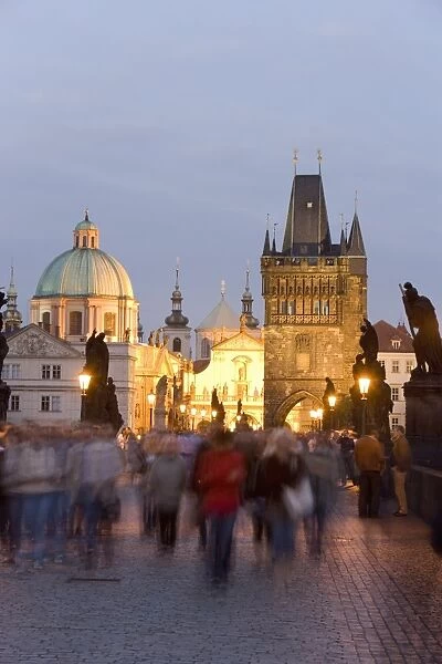 Crowds on the Charles Bridge, with the dome of the Church of St. Francis