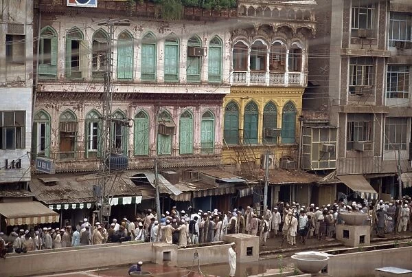 Crowds of men on a street in the old town of Peshawar