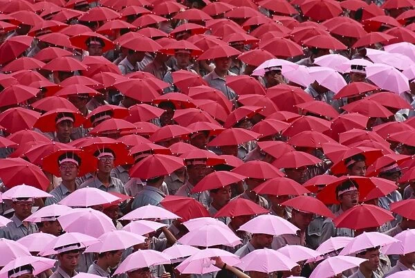 Crowds wearing red and pink umbrella hats during the