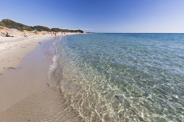 The crystal turquoise water of the sea frames the sandy beach, Sant Elmo Castiadas
