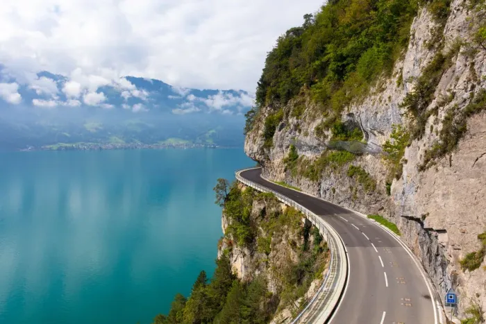 Framed Print : A curved road built into the side of a mountain next to Lake Thun, Interlaken, Bernese Oberland Framed Print : A curved road built into the side of a mountain next to Lake Thun, Interlaken, Bernese Oberland
