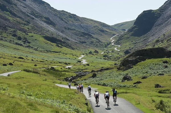 Cyclists ascending Honister Pass, Lake District National Park, Cumbria, England, United Kingdom, Europe