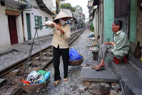 Daily life by the railway tracks in central Hanoi