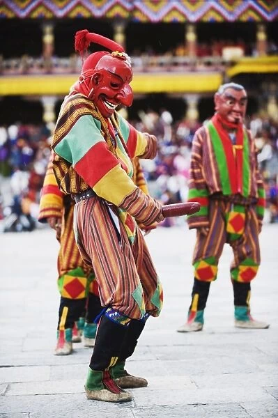 Dancer holding wooden penis, Autumn Tsechu (festival) at Trashi Chhoe Dzong
