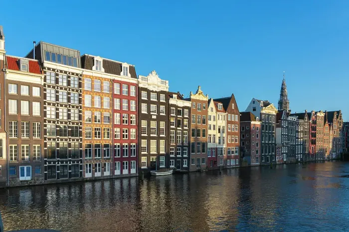 Framed Print : Dancing houses at Damrak and tower of Oude Kerk Amsterdam Church at sunset, Amsterdam, The Netherlands, Europe Framed Print : Dancing houses at Damrak and tower of Oude Kerk Amsterdam Church at sunset, Amsterdam, The Netherlands, Europe
