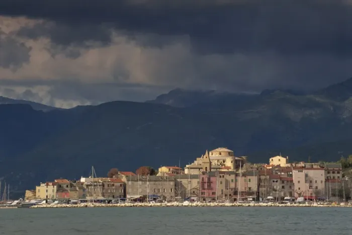 Framed Print : Dark clouds over hills and the skyline of the town of St. Florent on Cap Corse on the island of Corsica, France Framed Print : Dark clouds over hills and the skyline of the town of St. Florent on Cap Corse on the island of Corsica, France