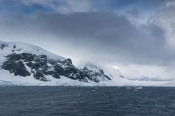 Dark clouds over the mountains and glaciers of Port Lockroy research station, Antarctica, Polar Regions