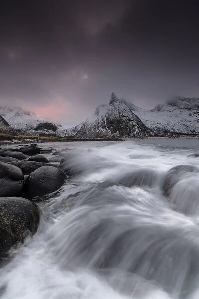 Dark clouds above snowy peaks and waves of the cold sea, Senja, Ersfjord, Troms county