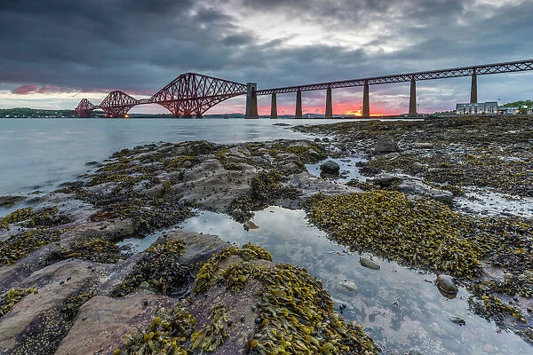 Dawn breaks over the Forth Rail Bridge, UNESCO World Heritage Site, and the Firth of Forth
