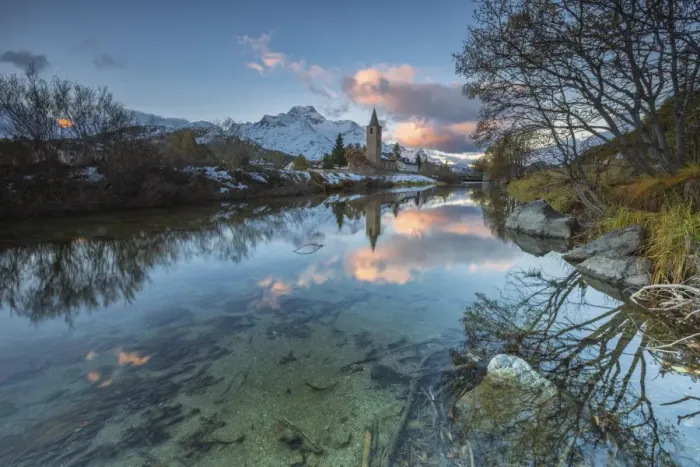 Framed Print : Dawn illuminates the snowy peaks and the bell tower reflected in Lake Sils, Engadine Framed Print : Dawn illuminates the snowy peaks and the bell tower reflected in Lake Sils, Engadine
