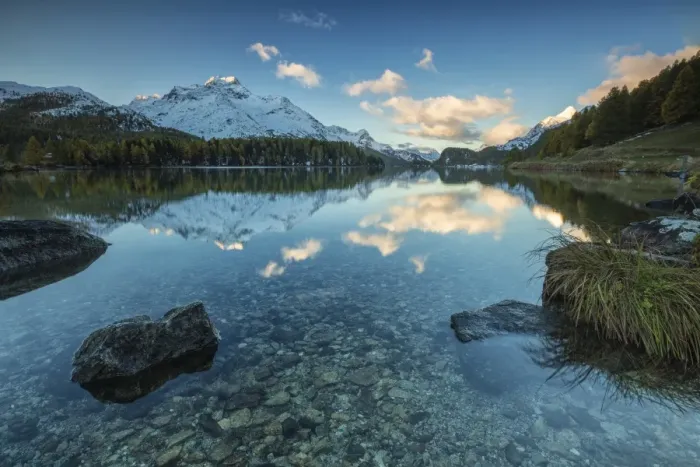 Framed Print : Dawn illuminates the snowy peaks reflected in the calm waters of Lake Sils, Engadine Framed Print : Dawn illuminates the snowy peaks reflected in the calm waters of Lake Sils, Engadine