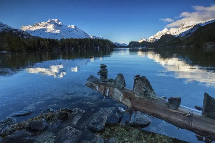 Framed Print : Dawn illuminates the snowy peaks reflected in the calm waters of Lake Sils, Engadine Framed Print : Dawn illuminates the snowy peaks reflected in the calm waters of Lake Sils, Engadine