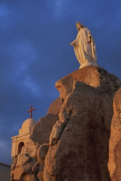 Dawn light on statue of the Virgin and the Chapel of Notre Dame de la Serra
