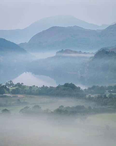 Dawn mist and mountain reflections in Llyn Gwynant, Snowdonia National Park, Wales, United Kingdom, Europe