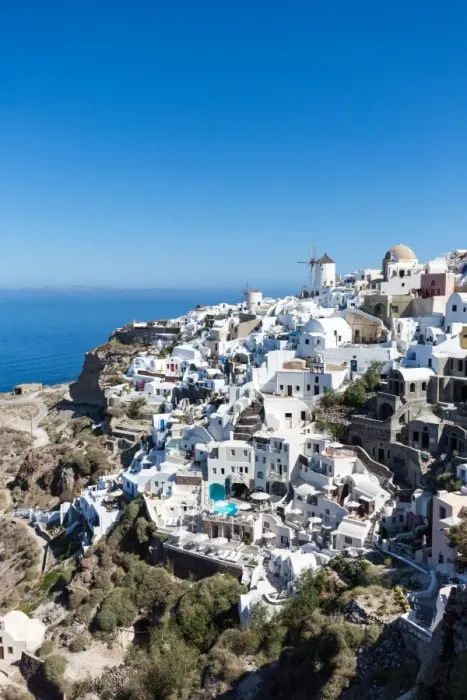 Framed Print : Day time view over the whitewashed buildings and windmill of Oia from the castle walls Framed Print : Day time view over the whitewashed buildings and windmill of Oia from the castle walls