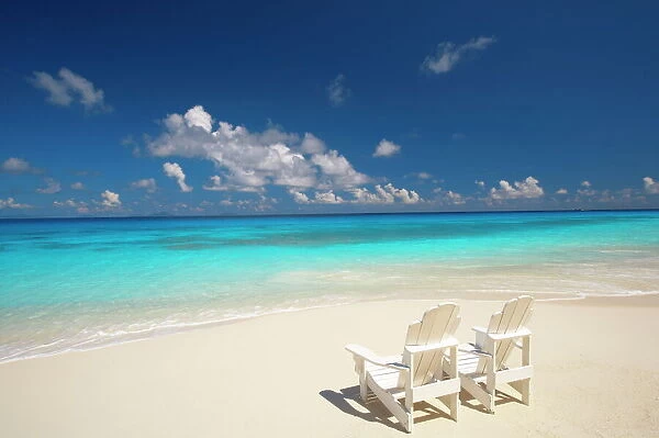 Two deck chairs on tropical beach facing sea, Maldives, Indian Ocean, Asia