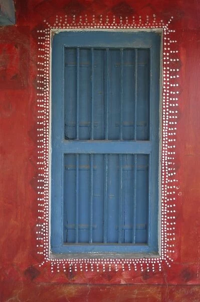 Decorated shuttered window in painted bhunga wall, Dhordo village, Kachchh