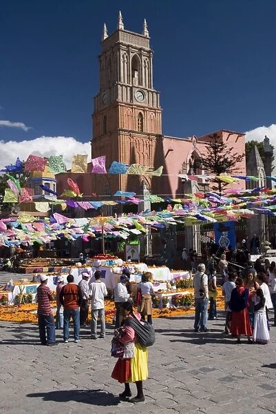 Decorations for the Day of the Dead festival, with Iglesia de San Rafael in the background