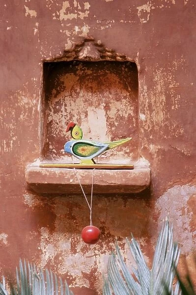 Decorative childs toy parrot in traditional wall niche